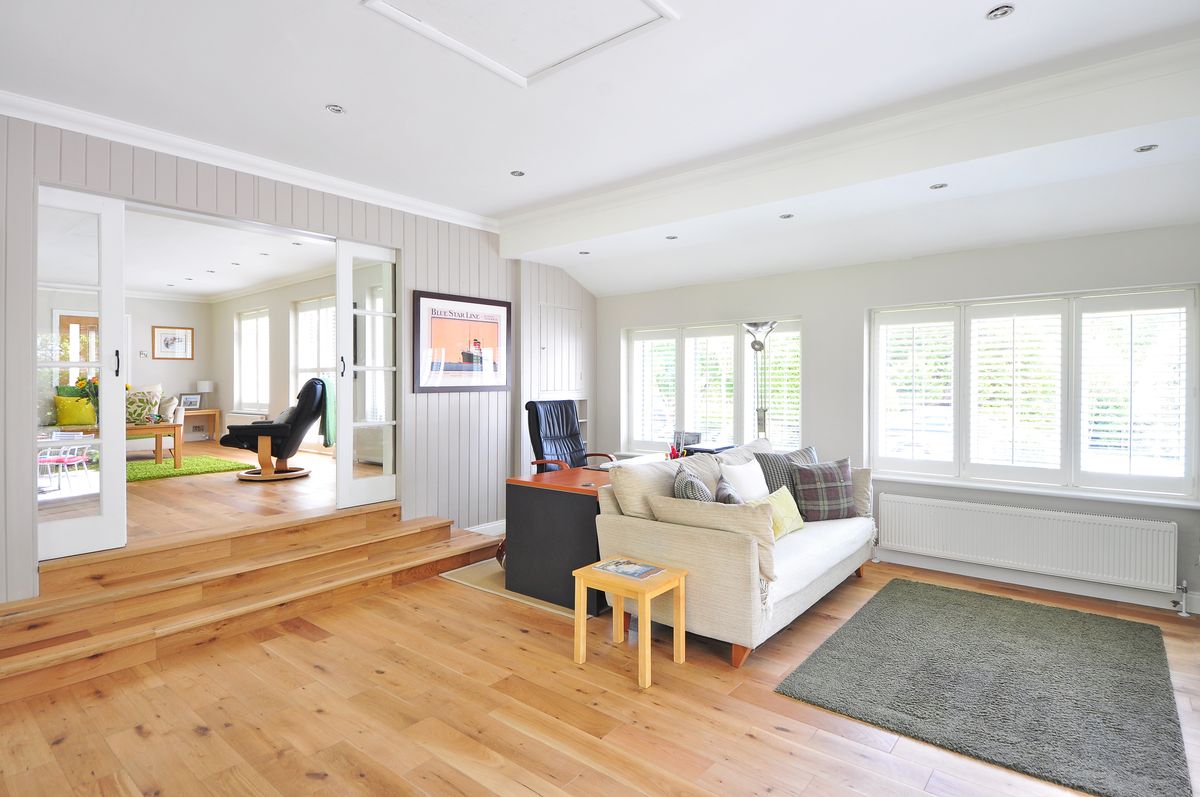 Illustrative dining space with timber table, seating and pendant lights
