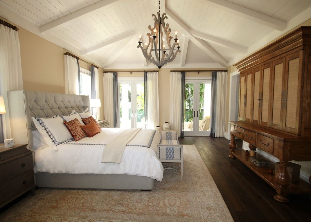 Illustrative furnished guest room with bed, seating and storage